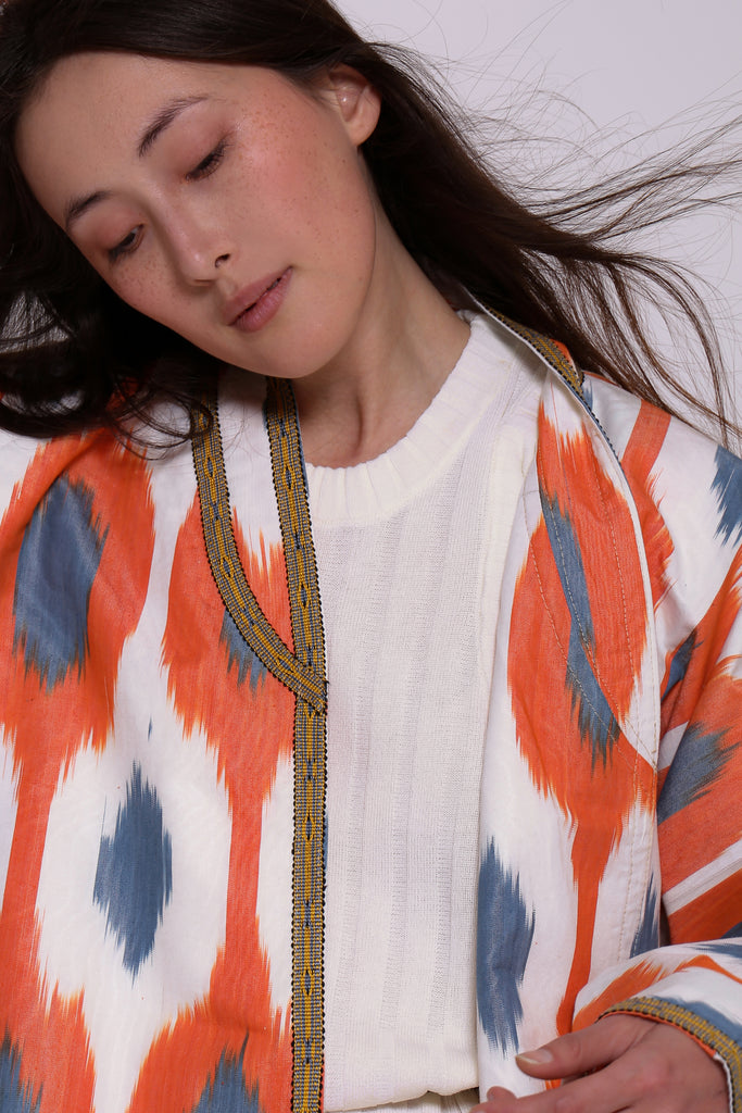 Woman wearing a orange and white kimono