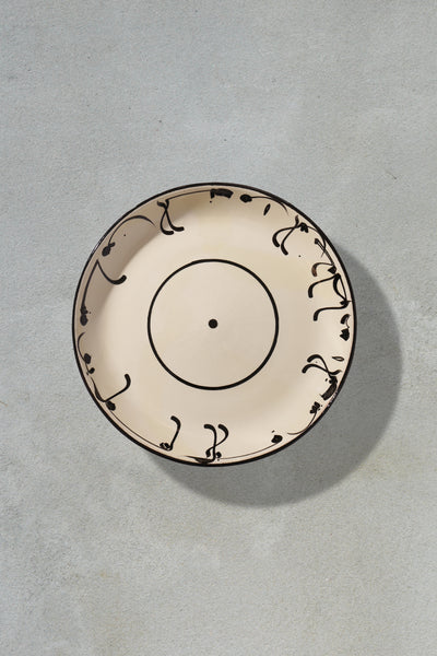 White ceramic plate with black writtings